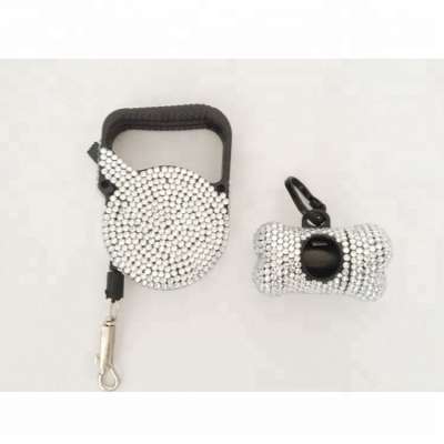 white rhinestone retractable dog leash with dog poop bag dispenser